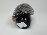 a rock with a tag on it sitting on a table