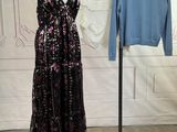 a dress on a mannequin stand next to a sweater on a hanger