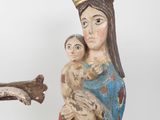 a statue of a woman holding a baby and a bird