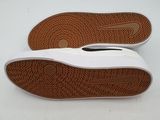 the sole of a pair of white shoes on a white surface