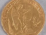 a close up of a gold coin with an angel on it