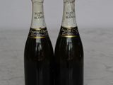 two bottles of champagne sitting on a marble table