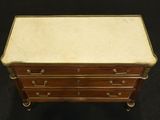 an antique wooden chest of drawers with marble top