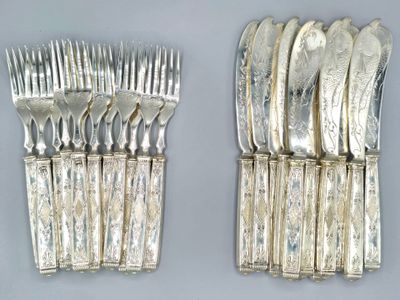 a lot of forks and spoons that are on the table