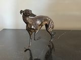 bronze statue of a dog on a black table