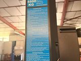 a sign on the side of a machine in a warehouse