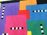 a colorful rug with a black and white stripe on it