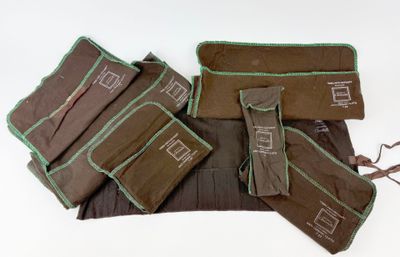 a group of brown and green bags on a white surface