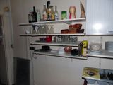 a small kitchen with a lot of dishes and dishes on the shelves