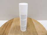 a tube of lotion sitting on top of a wooden table
