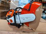 an orange and white chainsaw sitting on top of a cardboard box