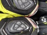 pair of black and yellow motorcycle gloves sitting on top of each other