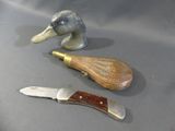 two knives and a duck head on a table