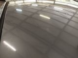 a car that is parked in a garage with a lot of windows