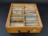 a suitcase full of old records on a black table