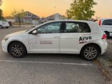 the white car is parked in a parking lot with other cars