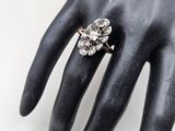 an image of a close up of a person ' s hand with a ring on it