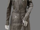 female mannequin dressed in a brown and white plaid coat and skirt