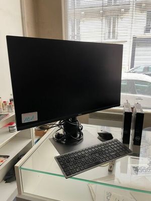 a computer desk with a monitor and keyboard on it