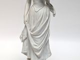 statue of a woman holding a basket of flowers on a pedestal