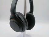 a pair of headphones on a stand on a white surface