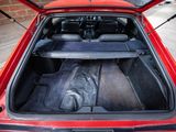 a red car with its trunk open on the street