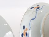 two white vases with blue and orange designs on them