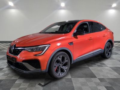un 4x4 rouge garé dans un garage au sol en damier