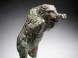 a close up of a statue of a dog on a white surface