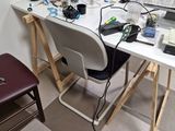 a white desk with a laptop on it and a chair
