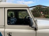 a white truck with a blue stripe on the side of it