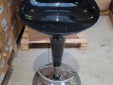 an image of a black stool in a warehouse
