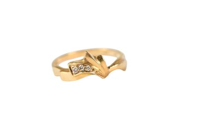a close up of a gold ring with a diamond on it