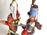 three toy soldiers that are standing on a table