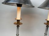 pair of metal and wood floor lamps with shades on them