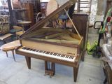 un piano à queue trônant dans une pièce remplie de meubles