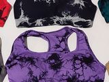 several sports bras are lined up on a white surface