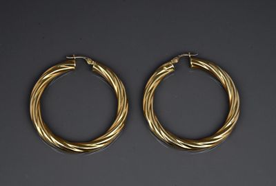 a pair of gold hoop earrings