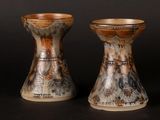 two vases sitting next to each other on a table