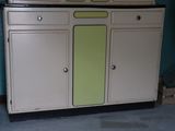 an old fashioned kitchen with a microwave on top of it