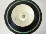 a black and white plate with a blue stripe around it