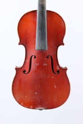 an old violin hanging from a string on a white background