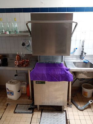 an image of a kitchen with a purple cloth on the floor