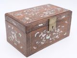 a small wooden box with a floral design on it