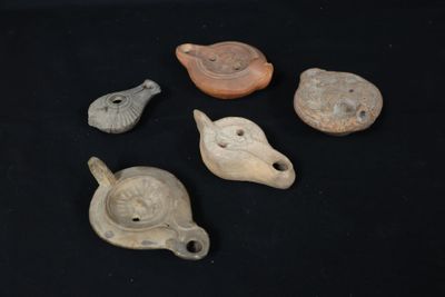 several different types of pottery items are displayed on a black surface