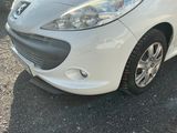 a picture of a white car parked in a parking lot