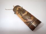 an old brass pipe with a design on it sitting on a white surface