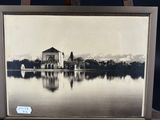 an old picture of a picture of a lake with a building in the background