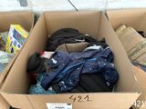 a cardboard box full of clothes and other items