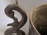 a close up of a vase with a bird on it